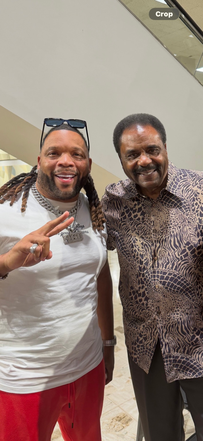 Two men posing together indoors