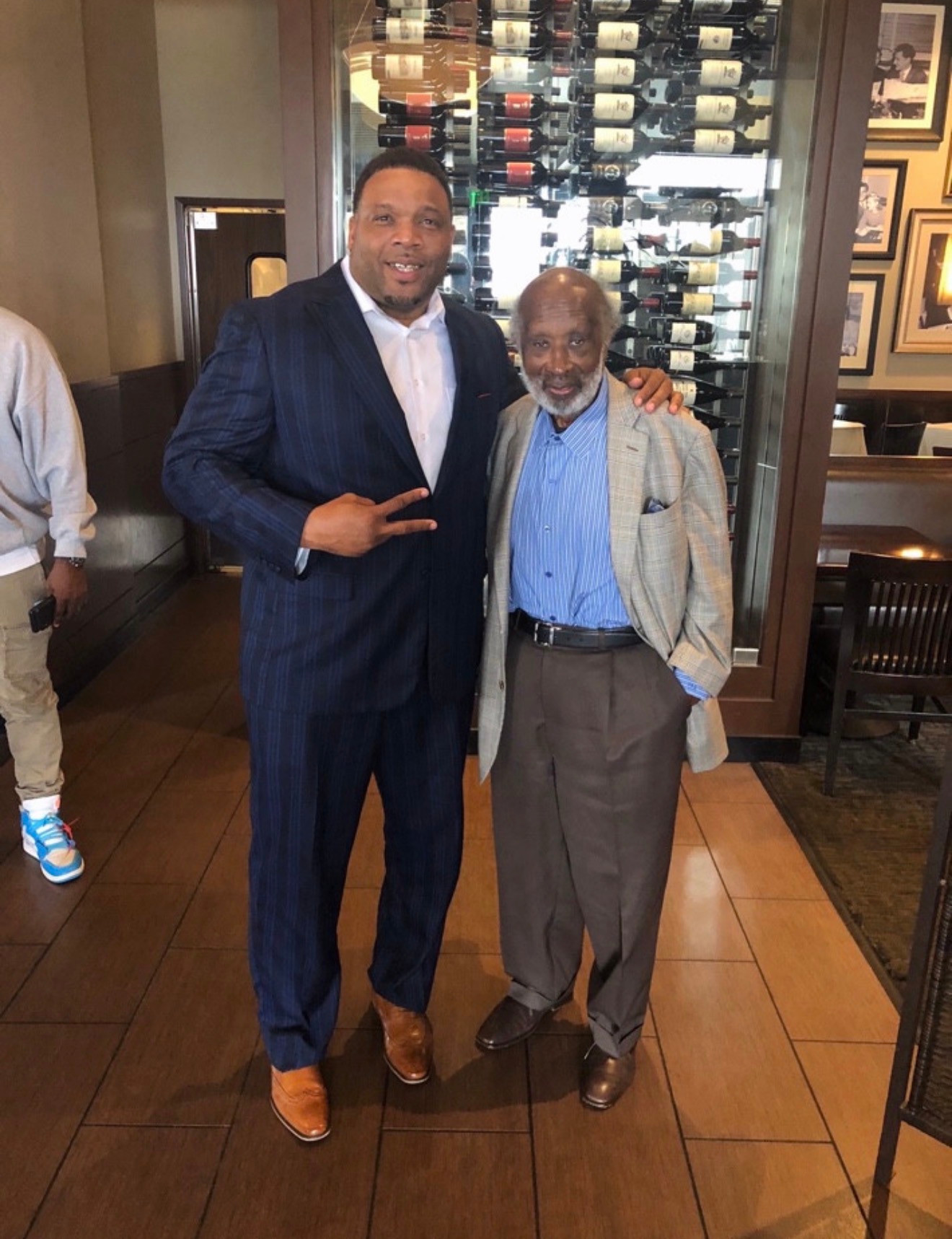 Two men standing together in suits
