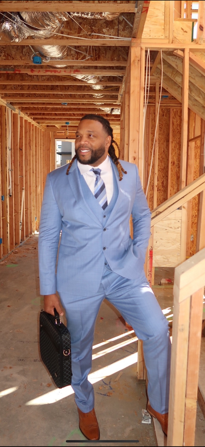 Full-length portrait in a light blue suit