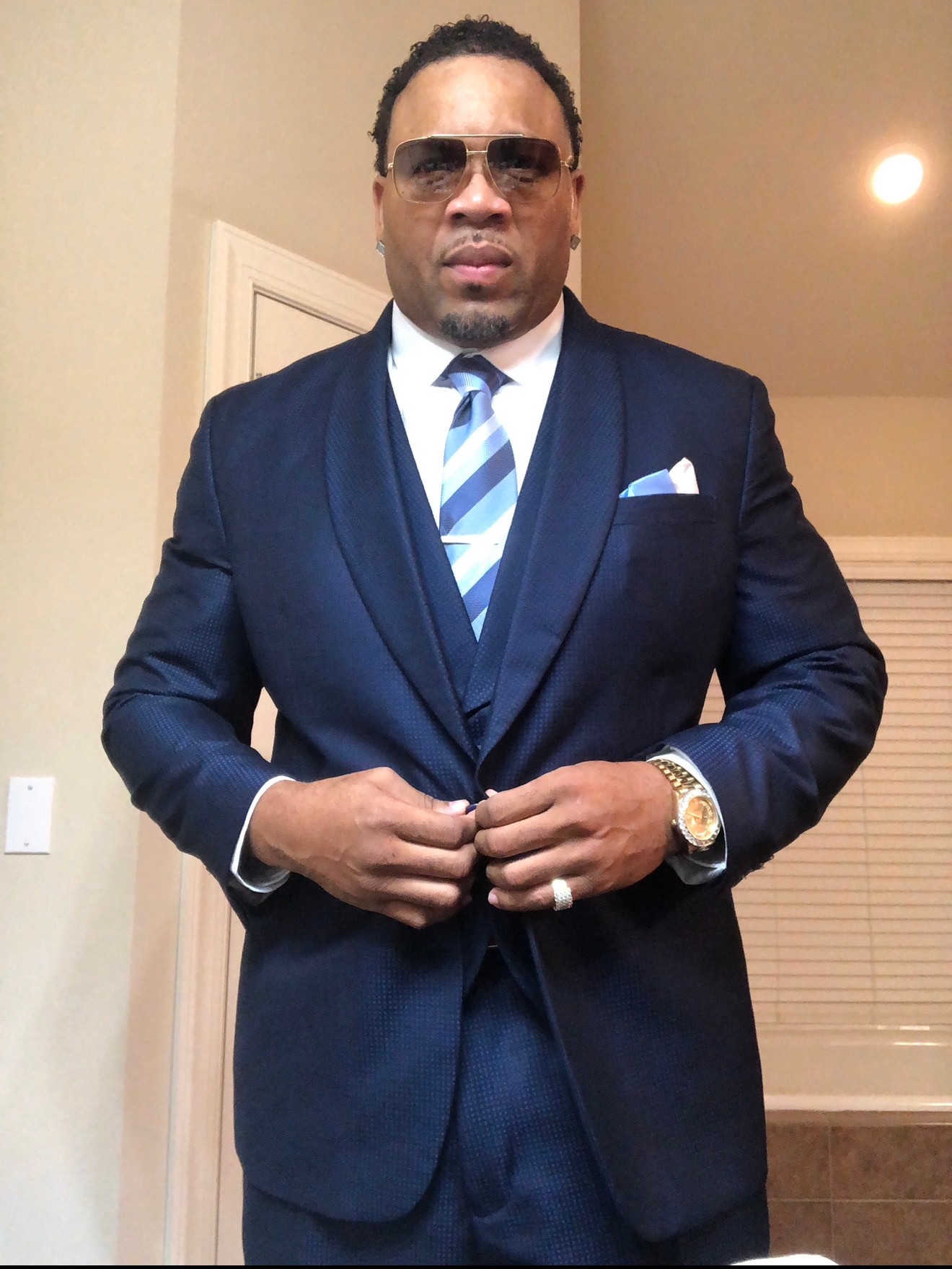 Portrait in a navy suit and sunglasses