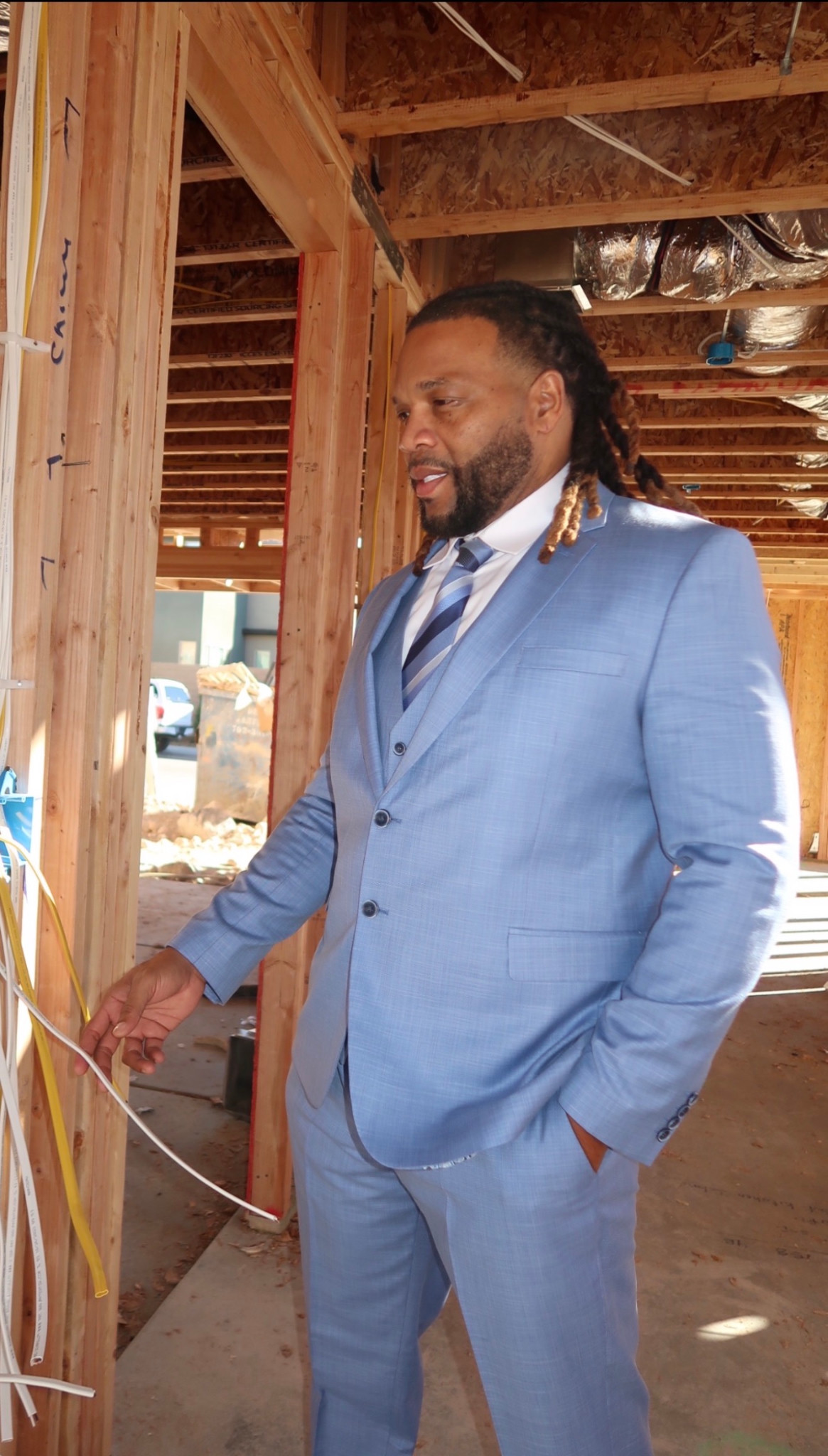 Three-quarter portrait in a light blue suit